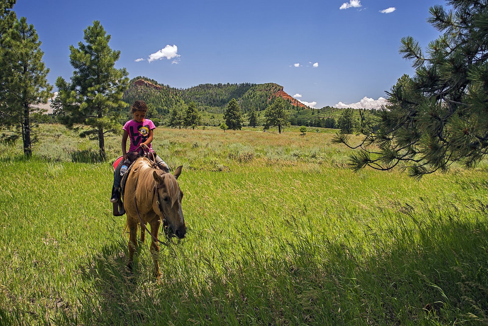 A young visitor travels through Bears Ears National Monument on horseback.