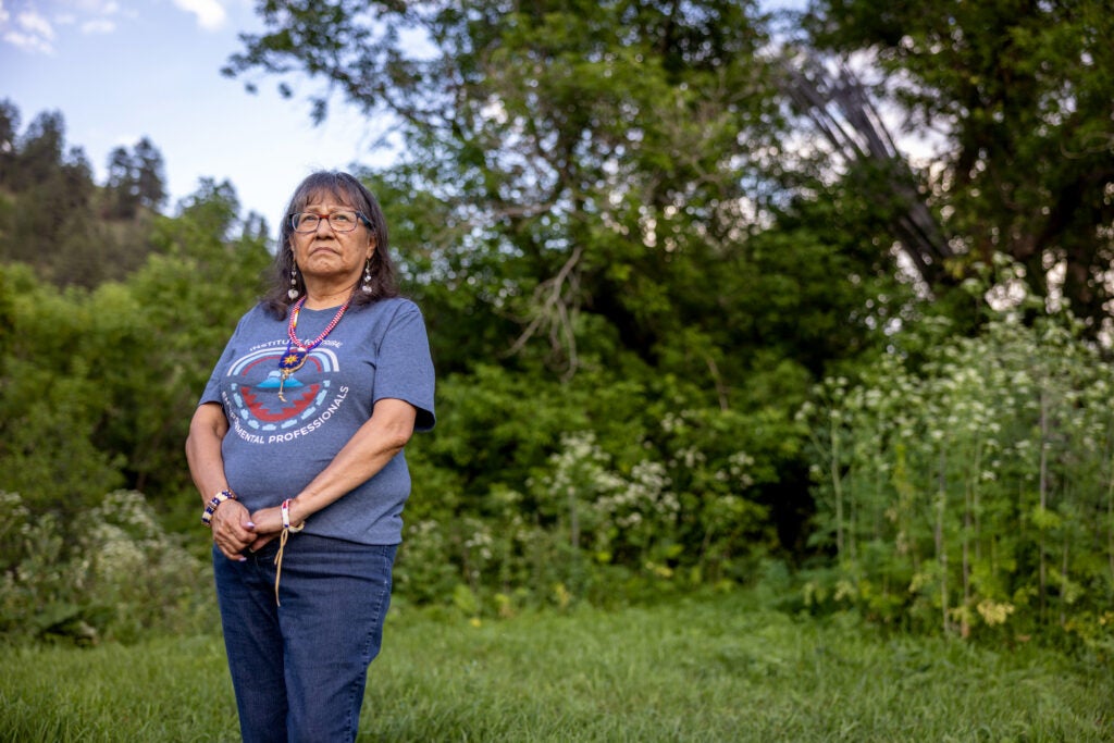 Charlene Alden stands outside her home in Lame Deer, Montana.